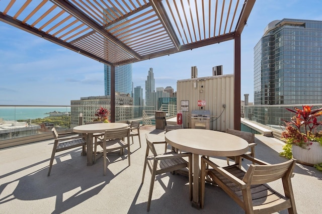 40 E 9th St Unit 802, Chicago, IL 60605 - view of patio featuring outdoor dining space, a pergola, and a view of skyline