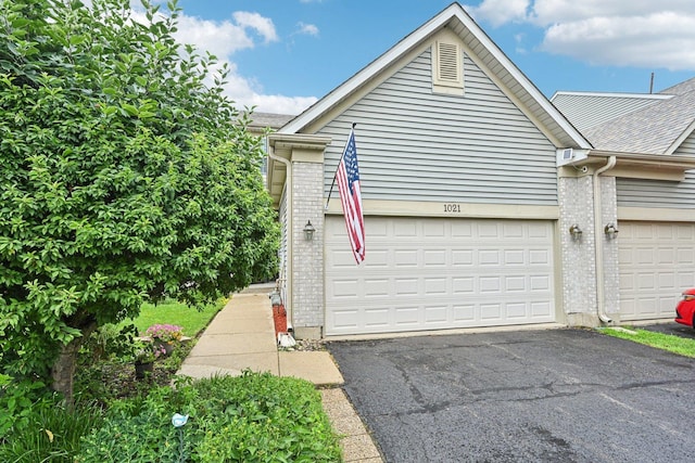 1021 Horizon Rdg, Lake In The Hills, IL 60156 - garage featuring asphalt driveway