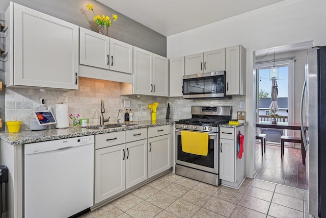 1021 Horizon Rdg, Lake In The Hills, IL 60156 - kitchen with stainless steel appliances, light stone counters, decorative backsplash, and light tile patterned floors