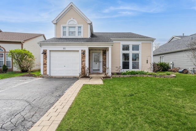80 Wilton Ln, Mundelein, IL 60060 - view of front of home with driveway, a front yard, a garage, and a shingled roof