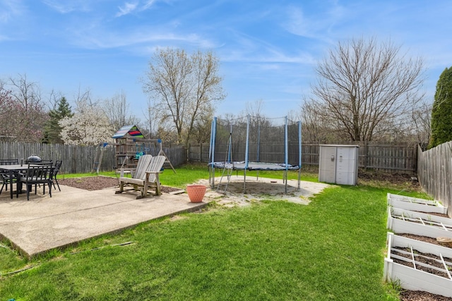 80 Wilton Ln, Mundelein, IL 60060 - fenced backyard featuring a trampoline, a playground, a patio area, and a storage shed