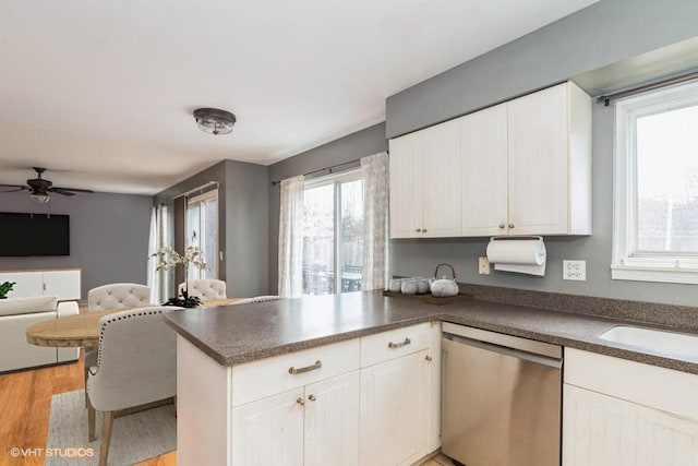 80 Wilton Ln, Mundelein, IL 60060 - kitchen with stainless steel dishwasher, a peninsula, dark countertops, and healthy amount of natural light