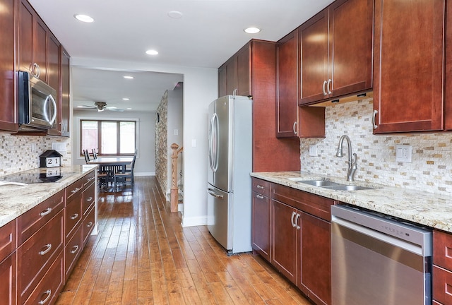 18W761 83rd St, Downers Grove, IL 60516 - kitchen featuring stainless steel appliances, ceiling fan, light wood finished floors, backsplash, and light stone countertops