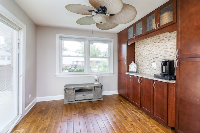 18W761 83rd St, Downers Grove, IL 60516 - kitchen with ceiling fan, wood-type flooring, glass insert cabinets, backsplash, and light stone counters