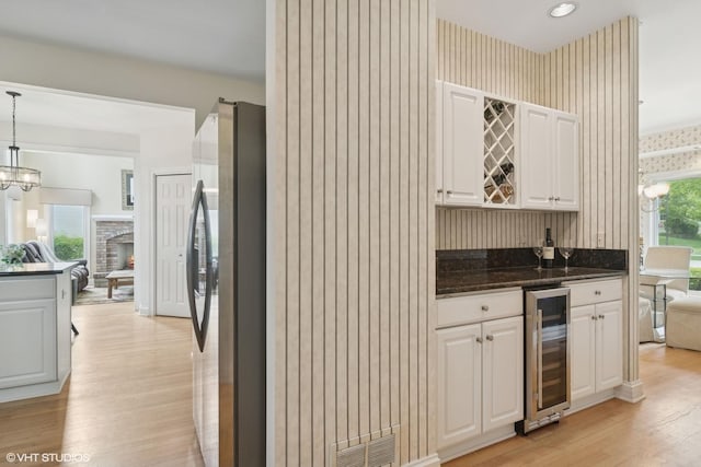 1580 W N St, Palatine, IL 60067 - kitchen featuring wine cooler, freestanding refrigerator, wallpapered walls, light wood finished floors, and open floor plan