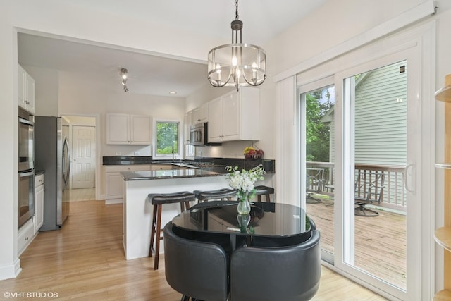 1580 W N St, Palatine, IL 60067 - kitchen featuring stainless steel appliances, white cabinetry, a peninsula, and light wood-type flooring