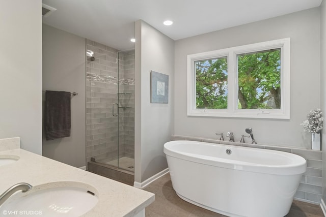 1580 W N St, Palatine, IL 60067 - bathroom featuring a stall shower, a freestanding bath, double vanity, and recessed lighting
