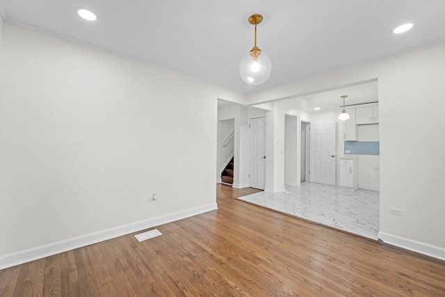 8416 S Bennett Ave, Chicago, IL 60617 - unfurnished living room featuring stairway, recessed lighting, wood finished floors, and crown molding