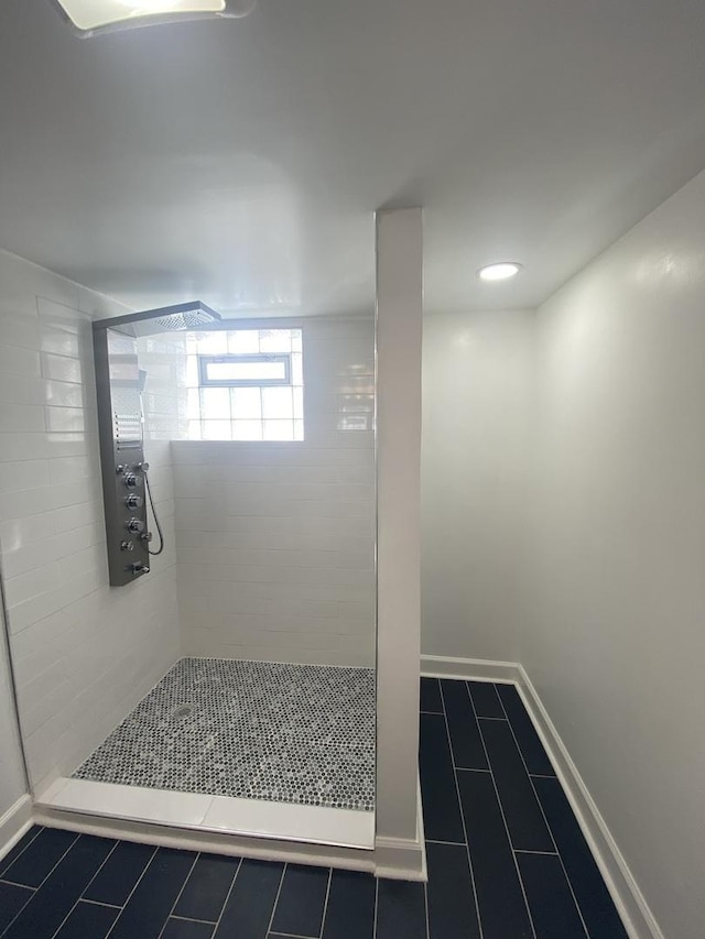8416 S Bennett Ave, Chicago, IL 60617 - bathroom featuring a tile shower and tile patterned flooring