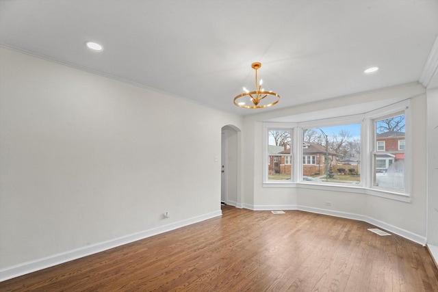 8416 S Bennett Ave, Chicago, IL 60617 - empty room featuring arched walkways, a chandelier, ornamental molding, wood finished floors, and recessed lighting
