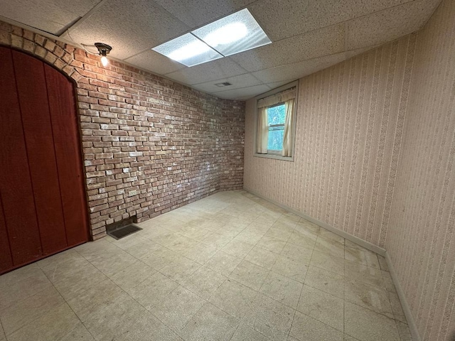 2518 Spring Creek Rd, Belvidere, IL 61008 - basement featuring a drop ceiling, tile patterned floors, and brick wall