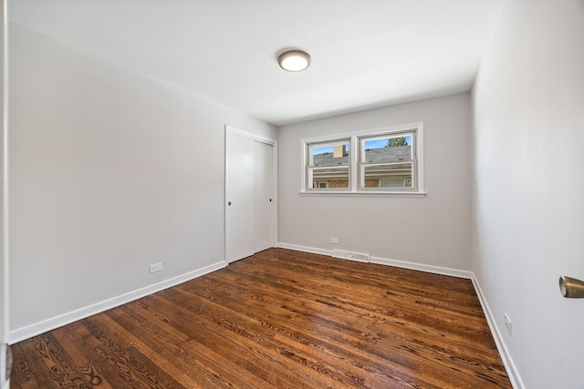 4850 N Clifton Ave, Norridge, IL 60706 - spare room featuring dark wood-type flooring and baseboards