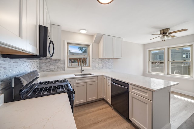 4850 N Clifton Ave, Norridge, IL 60706 - kitchen featuring dishwashing machine, gas range, a peninsula, light wood-type flooring, and tasteful backsplash