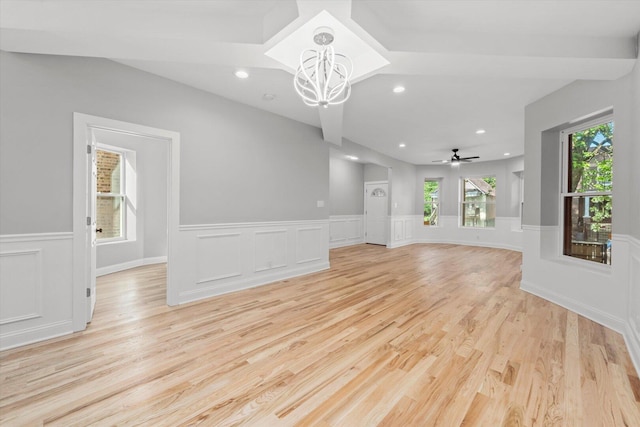 5726 S Elizabeth St, Chicago, IL 60636 - unfurnished living room featuring a chandelier, wainscoting, light wood finished floors, a decorative wall, and ceiling fan