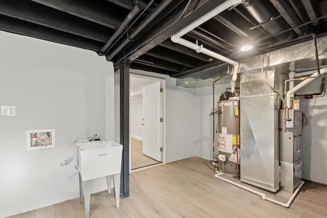 5726 S Elizabeth St, Chicago, IL 60636 - below grade area featuring water heater, heating unit, and wood finished floors