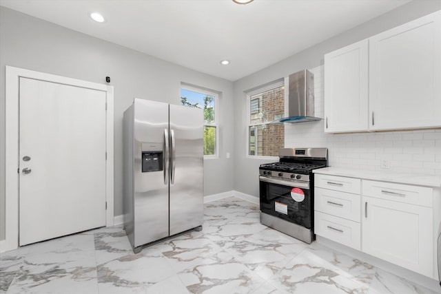 5726 S Elizabeth St, Chicago, IL 60636 - kitchen with stainless steel appliances, wall chimney range hood, light marble finish floors, white cabinets, and tasteful backsplash
