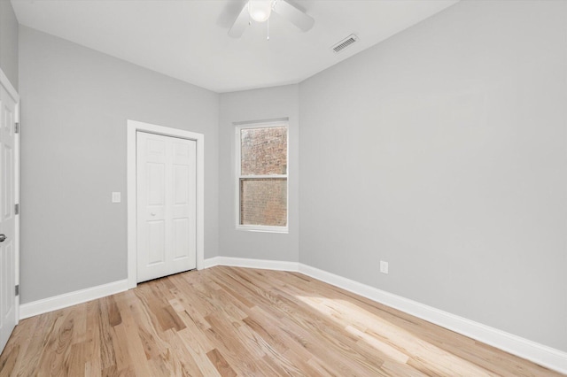 5726 S Elizabeth St, Chicago, IL 60636 - unfurnished bedroom with light wood-style flooring and ceiling fan