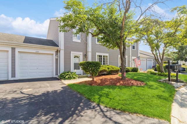 1335 Chelsea Cv, Roselle, IL 60172 - townhome / multi-family property with driveway, an attached garage, a front yard, and roof with shingles