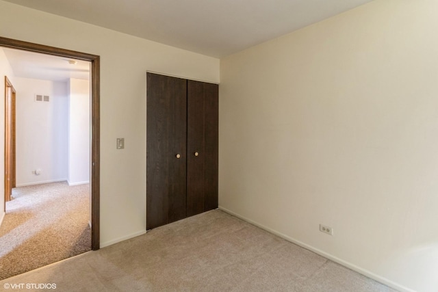 1335 Chelsea Cv, Roselle, IL 60172 - unfurnished bedroom featuring light colored carpet and a closet
