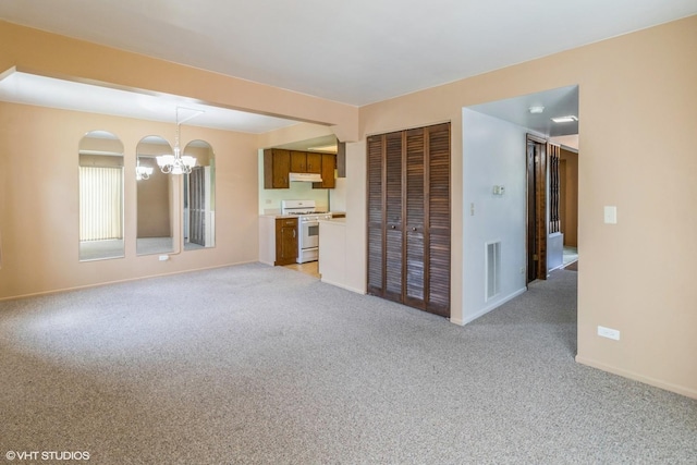 1335 Chelsea Cv, Roselle, IL 60172 - unfurnished living room with a chandelier and light colored carpet