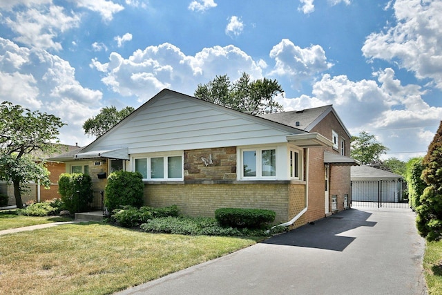 8532 N Olcott Ave, Niles, IL 60714 - view of front facade with brick siding, a front lawn, and a detached garage