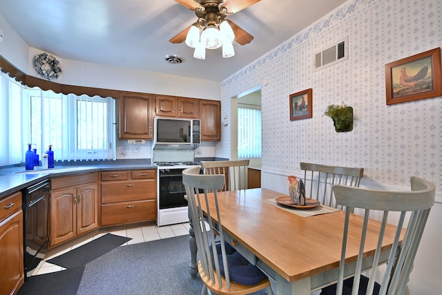 8532 N Olcott Ave, Niles, IL 60714 - kitchen featuring stainless steel microwave, gas range oven, dishwasher, plenty of natural light, and wallpapered walls
