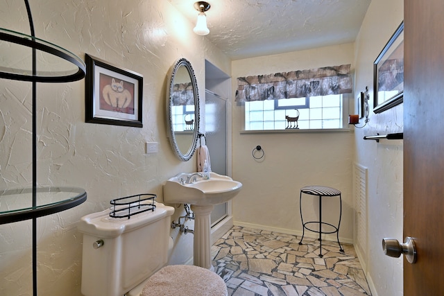 8532 N Olcott Ave, Niles, IL 60714 - bathroom featuring a textured wall, a textured ceiling, and stone finish flooring