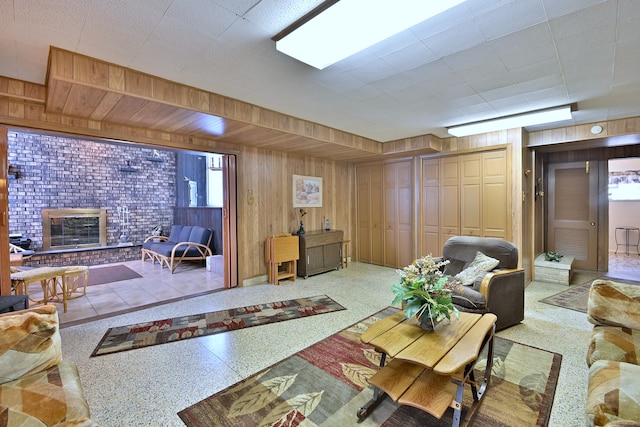8532 N Olcott Ave, Niles, IL 60714 - living room featuring wood walls, a brick fireplace, and speckle patterned floor