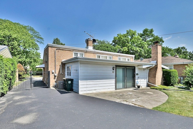 8532 N Olcott Ave, Niles, IL 60714 - back of property with a gate and a chimney