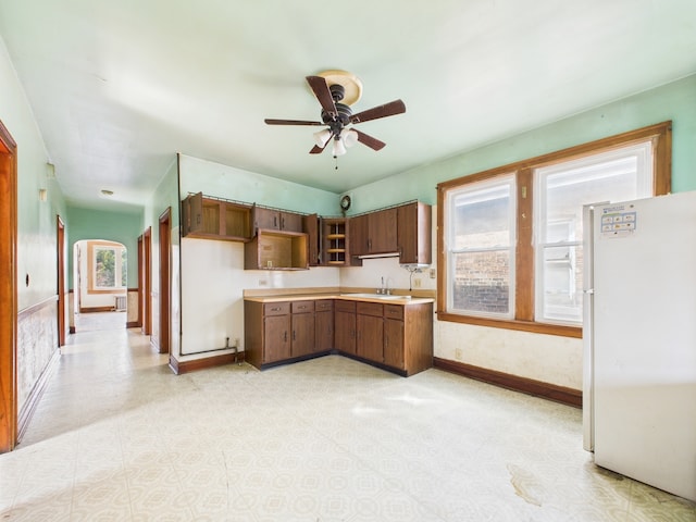 3109 W 53rd Pl, Chicago, IL 60632 - kitchen with freestanding refrigerator, a ceiling fan, light countertops, and arched walkways