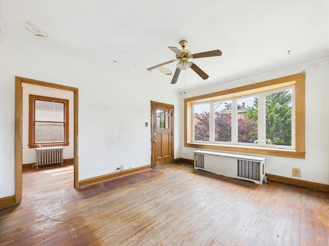 3109 W 53rd Pl, Chicago, IL 60632 - empty room featuring radiator, radiator heating unit, crown molding, wood-type flooring, and ceiling fan