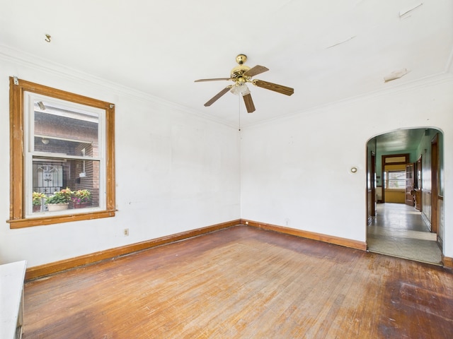 3109 W 53rd Pl, Chicago, IL 60632 - empty room featuring arched walkways, wood-type flooring, ceiling fan, and ornamental molding