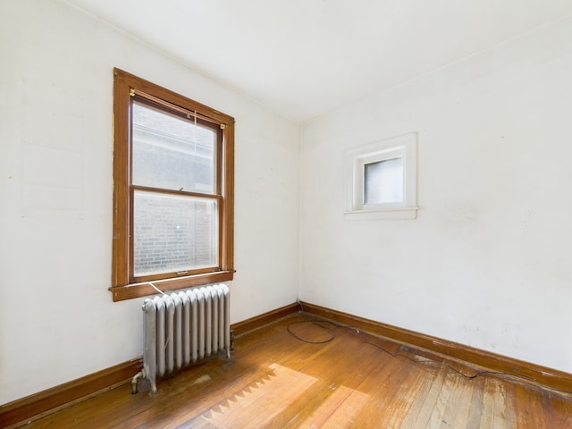 3109 W 53rd Pl, Chicago, IL 60632 - empty room with radiator heating unit, healthy amount of natural light, and hardwood / wood-style flooring
