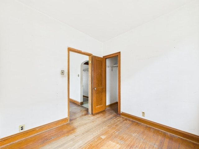 3109 W 53rd Pl, Chicago, IL 60632 - empty room featuring arched walkways and light wood-type flooring