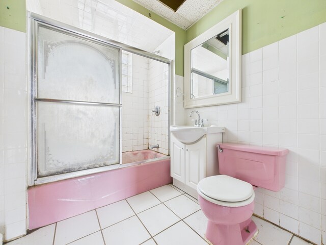 3109 W 53rd Pl, Chicago, IL 60632 - bathroom featuring vanity, tile walls, shower / bath combination with glass door, tile patterned flooring, and plenty of natural light