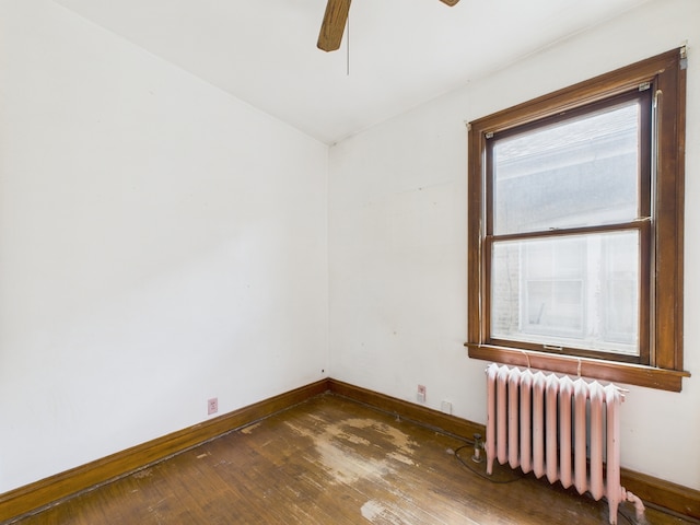 3109 W 53rd Pl, Chicago, IL 60632 - spare room featuring radiator heating unit, hardwood / wood-style floors, and a ceiling fan