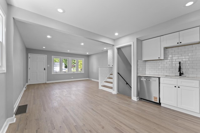 4025 Williams St, Downers Grove, IL 60515 - kitchen with dishwasher, light countertops, backsplash, light wood-style flooring, and white cabinetry