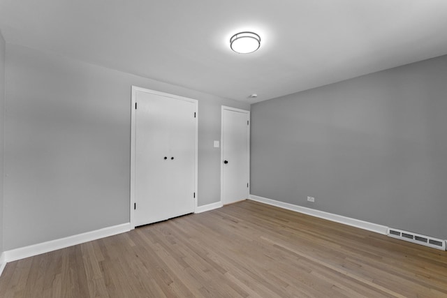 4025 Williams St, Downers Grove, IL 60515 - unfurnished bedroom with baseboards and wood finished floors