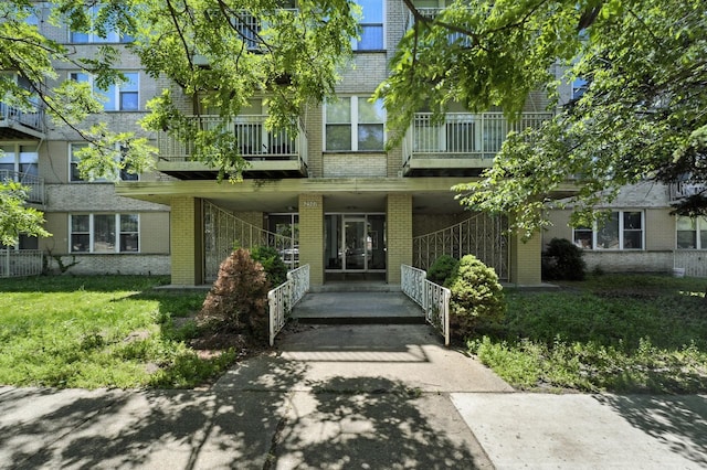 2501 W Touhy Ave Unit 105, Chicago, IL 60645 - doorway to property featuring brick siding
