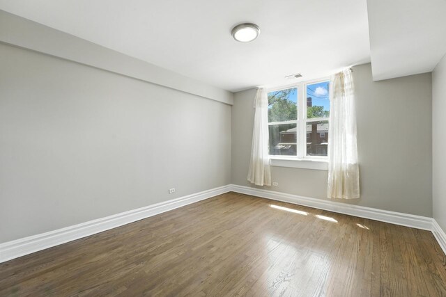 2501 W Touhy Ave Unit 105, Chicago, IL 60645 - unfurnished room featuring baseboards and wood finished floors