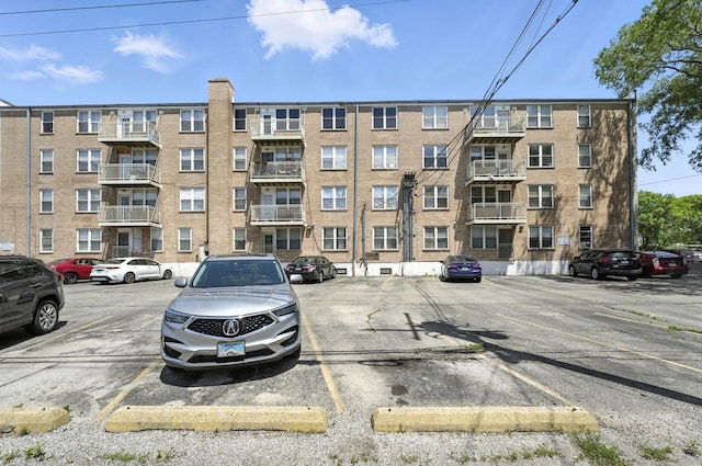 2501 W Touhy Ave Unit 105, Chicago, IL 60645 - view of apartment building / complex with uncovered parking