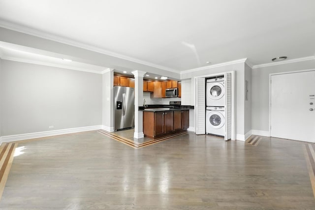 2501 W Touhy Ave Unit 105, Chicago, IL 60645 - kitchen with appliances with stainless steel finishes, stacked washer and clothes dryer, open floor plan, dark countertops, and dark wood-style flooring