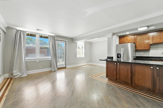 2501 W Touhy Ave Unit 105, Chicago, IL 60645 - kitchen with stainless steel fridge with ice dispenser, wood finished floors, dark countertops, healthy amount of natural light, and ornamental molding