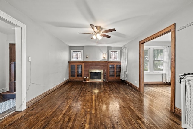 6510 Sinclair Ave, Berwyn, IL 60402 - unfurnished living room featuring a fireplace, plenty of natural light, wood-type flooring, and ceiling fan