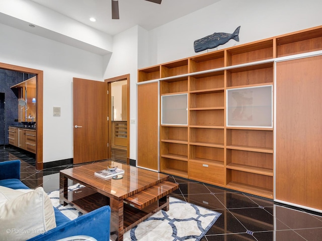 333 W Hubbard St Unit 1006, Chicago, IL 60654 - living area featuring a ceiling fan, granite tiled floors, recessed lighting, built in shelves, and a towering ceiling