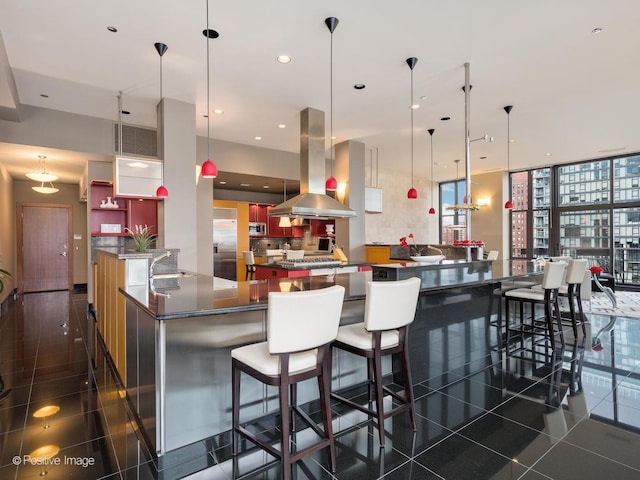 333 W Hubbard St Unit 1006, Chicago, IL 60654 - kitchen with island range hood, dark countertops, stainless steel built in fridge, dark tile patterned floors, and a large island