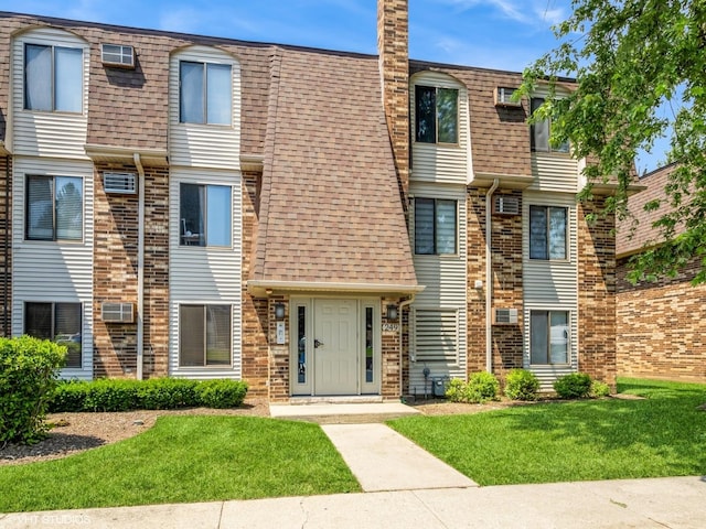 249 W Court Of Shorewood Unit 1B, Vernon Hills, IL 60061 - multi unit property featuring a front yard, a chimney, and a shingled roof