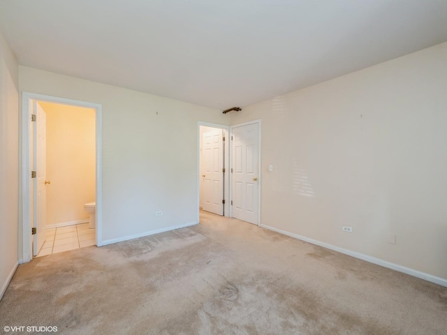 249 W Court Of Shorewood Unit 1B, Vernon Hills, IL 60061 - unfurnished bedroom with light colored carpet and ensuite bathroom