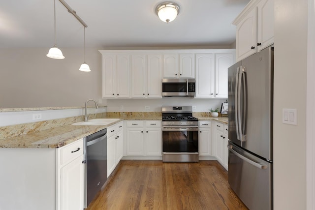 6112 Ironwood Ln, Lisle, IL 60532 - kitchen with appliances with stainless steel finishes, a peninsula, dark wood finished floors, and white cabinetry