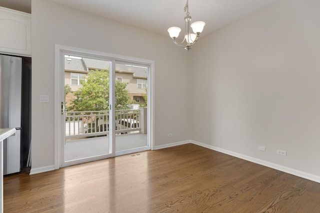 6112 Ironwood Ln, Lisle, IL 60532 - unfurnished room featuring a chandelier and wood finished floors